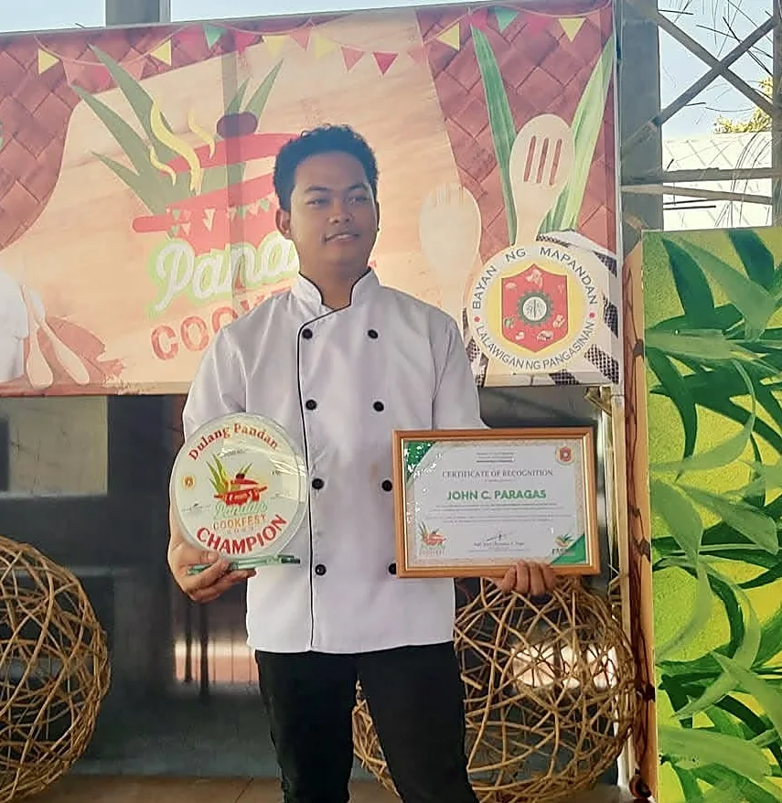 John C. Paragas holding the Pandan Cookfest Champion plaque and certificate