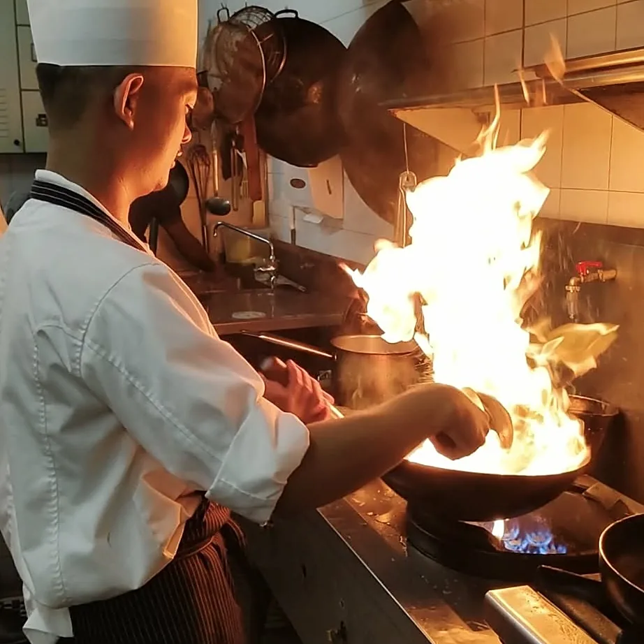 Chef John Paragas flambéing in the wok